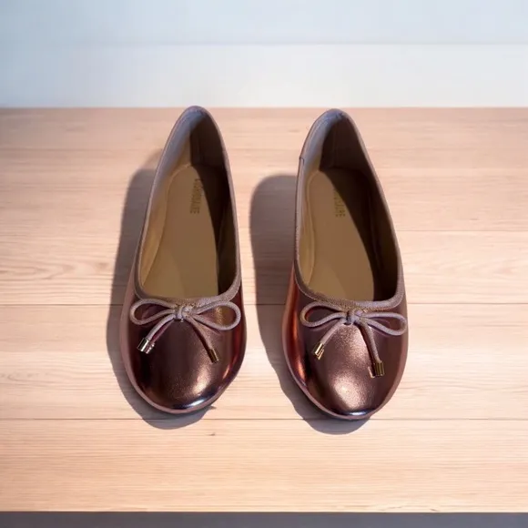 Cushionaire Pink Metallic ballet flats with bow accent.