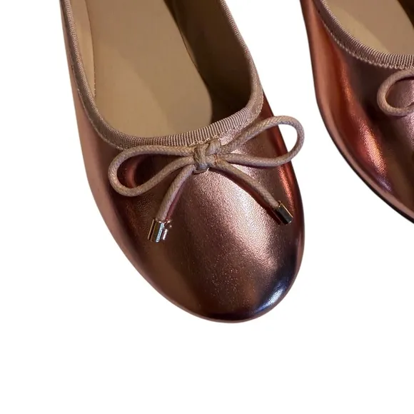 Cushionaire Pink Metallic ballet flats with bow accent.