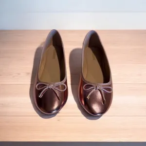 Cushionaire Pink Metallic ballet flats with bow accent.
