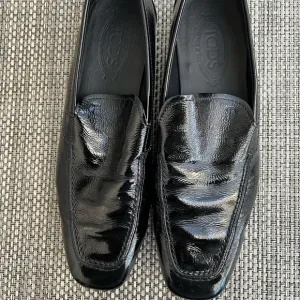 Men’s “TOD’S” Black Patent Leather Slip on Loafers