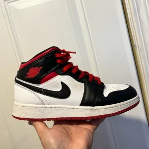 Nike Black and White Sneakers with Mid-Top Design