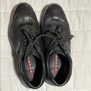 Prada Black Sneakers with Lace-Up Design and Versatile Style