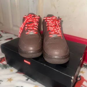 Supreme Brown Sneakers with Red Highlights